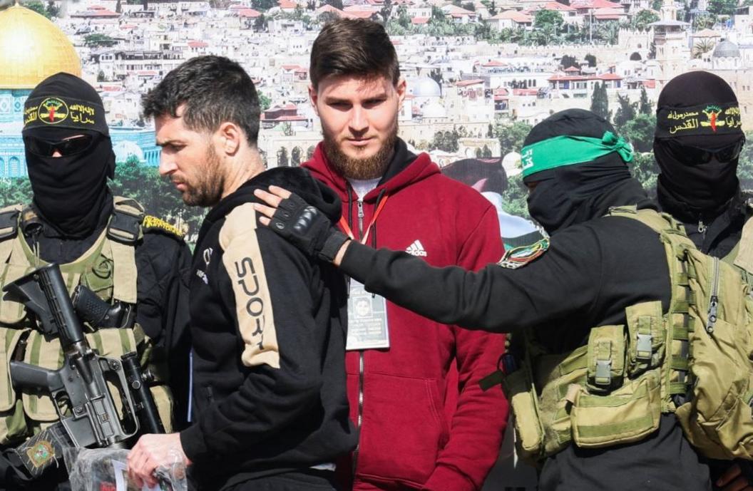 US-Israeli Sagui Dekel-Chen and Russian-Israeli Sasha (Alexander) Troufanov are escorted by Hamas militants and Islamic Jihad militants as part of a hostage-prisoners swap in Khan Younis, 15 February