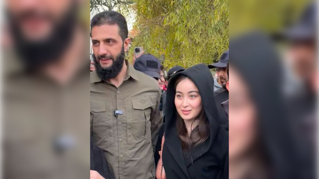 Ahmed al-Sharaa posing beside a young Syrian woman with her hood up