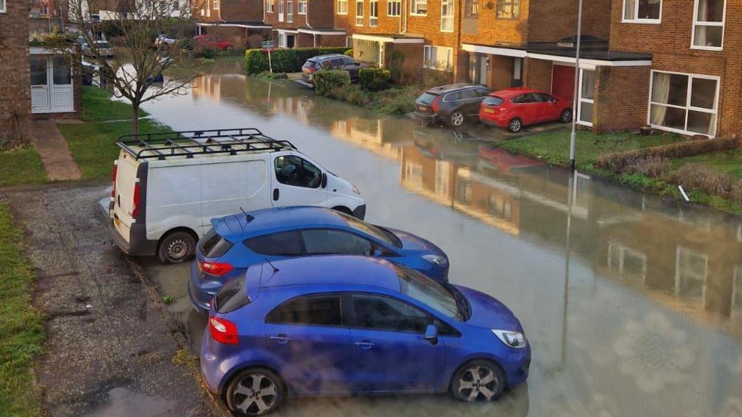 Vehicles parked in flooded street