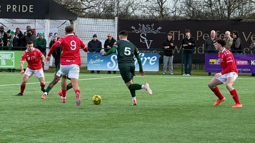 Action from Ashford United v Jersey Bulls