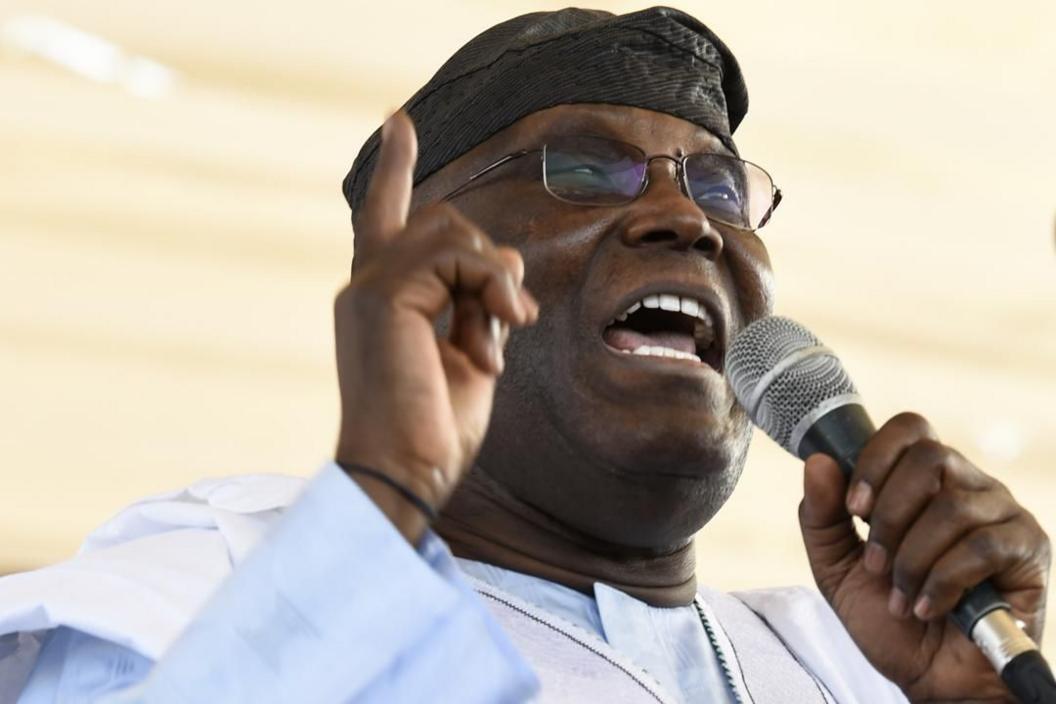 Former Nigerian vice president Atiku Abubakar wearing a traditional gown and holding a microphone