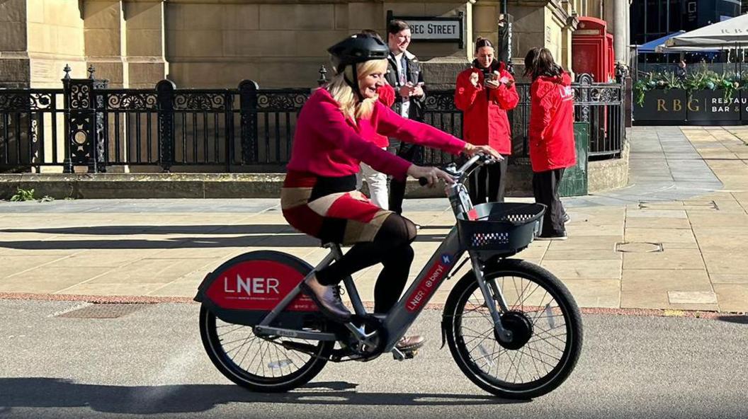 Tracy Brabin on an LNER Beryl bike in Leeds city centre.