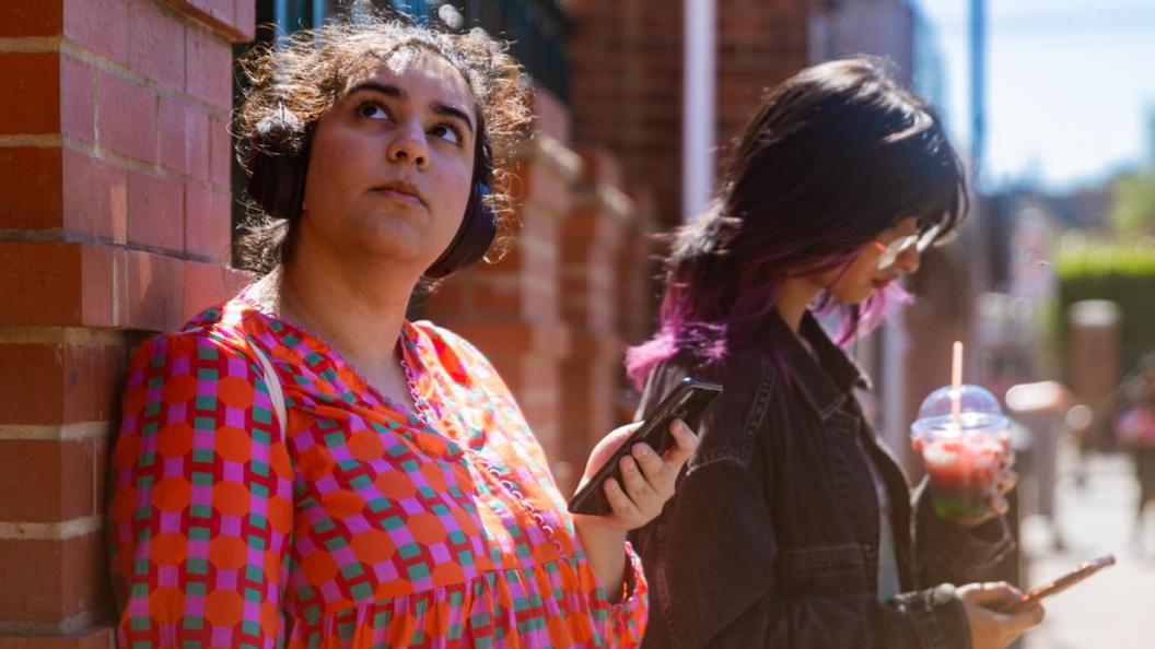 Two women listening to an audio story in Luton