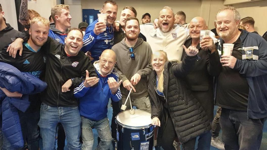 Nathan Parris with his drum and Ipswich supporters