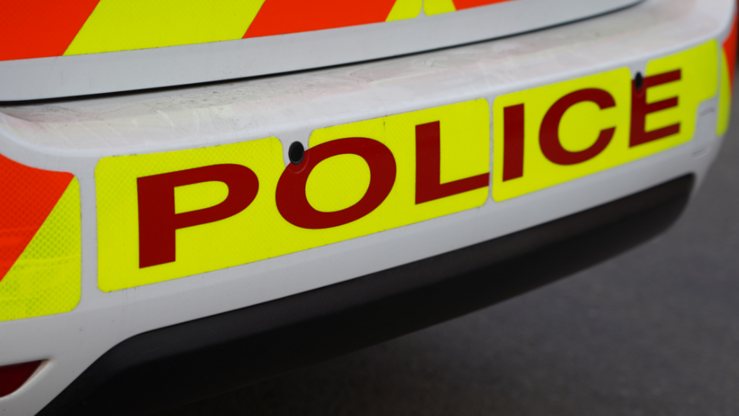 Rear of police car showing sign saying 'Police'