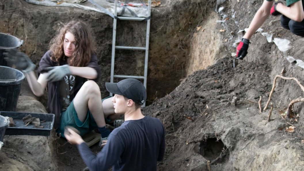 Two students in the trenches digging for skeletons and artefacts