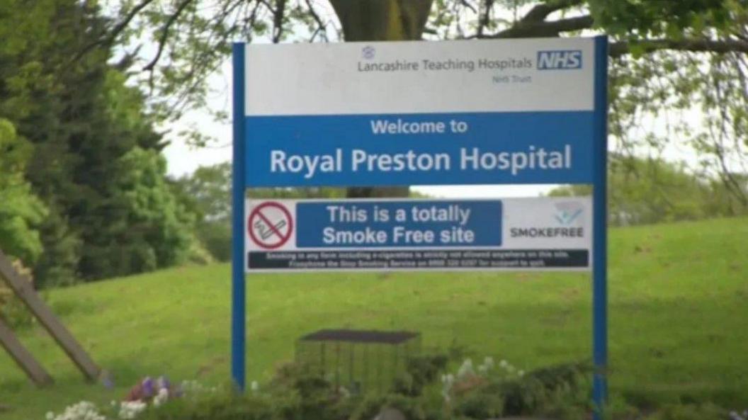 A sign in a grassy area outside the Royal Preston Hospital