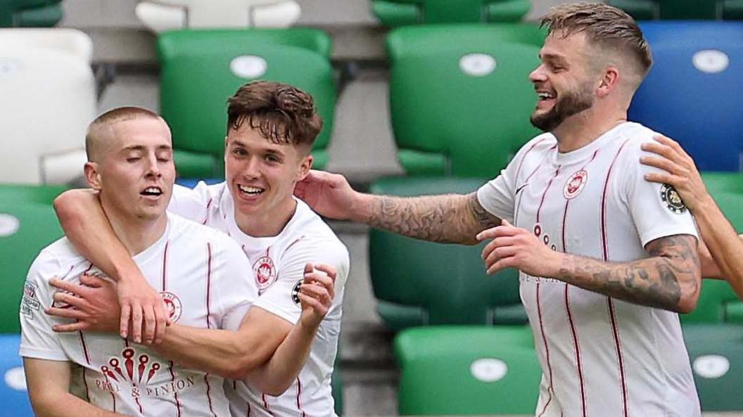 Larne players celebrate with goalscorer Conor McKendry