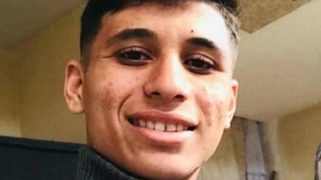 A young man, Abdullah Jendeia, smiles at the camera 