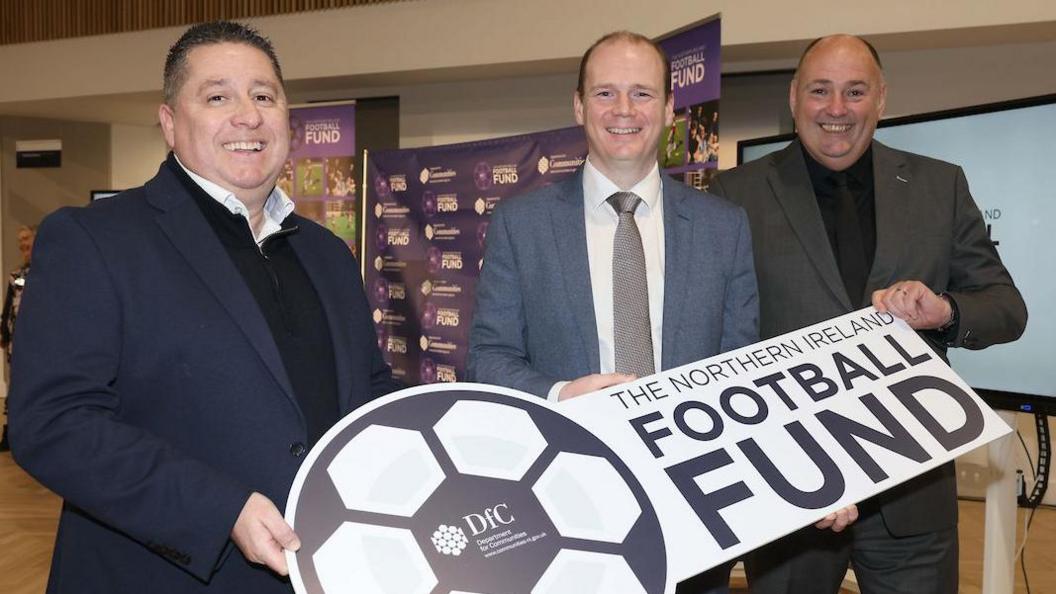 Gordon Lyons (centre) pictured pinch NIFL president Gerard Lawlor and IFA president Conrad Kirkwood 