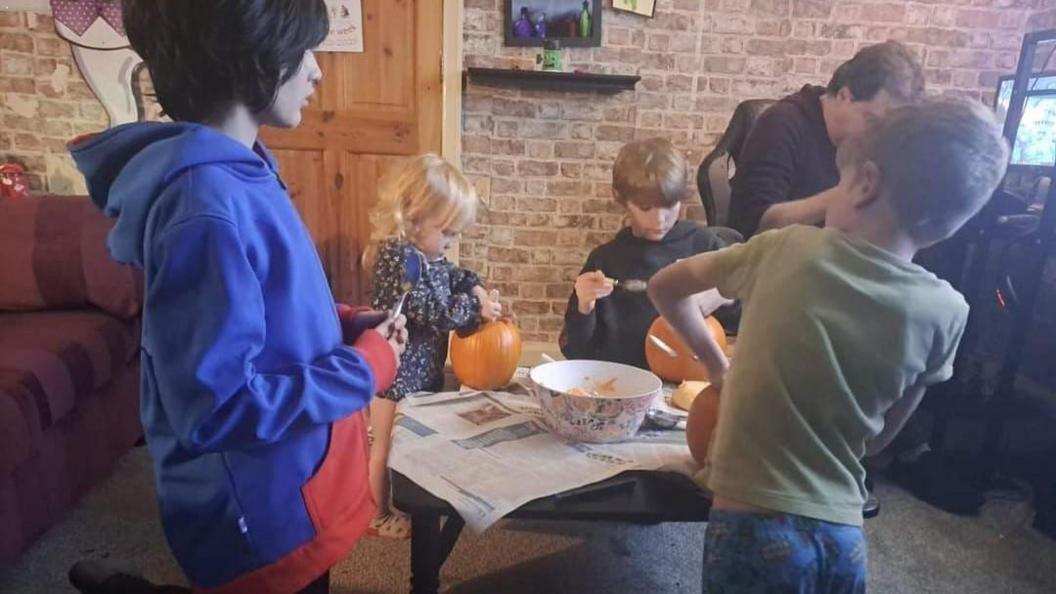 Ms Pollard's children carving pumpkins