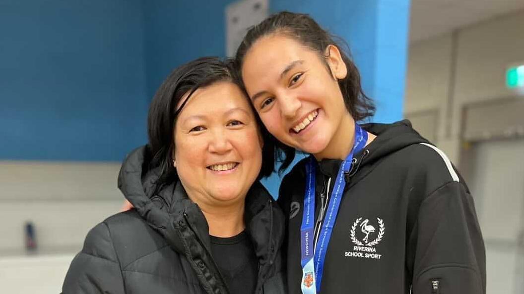 Maureen Fawns in black coat stands alongside daughter Sophie Fawns, who has a medal around her neck and is wearing a hooded top that was the wording Riviera School Sport beneath a bird emblem