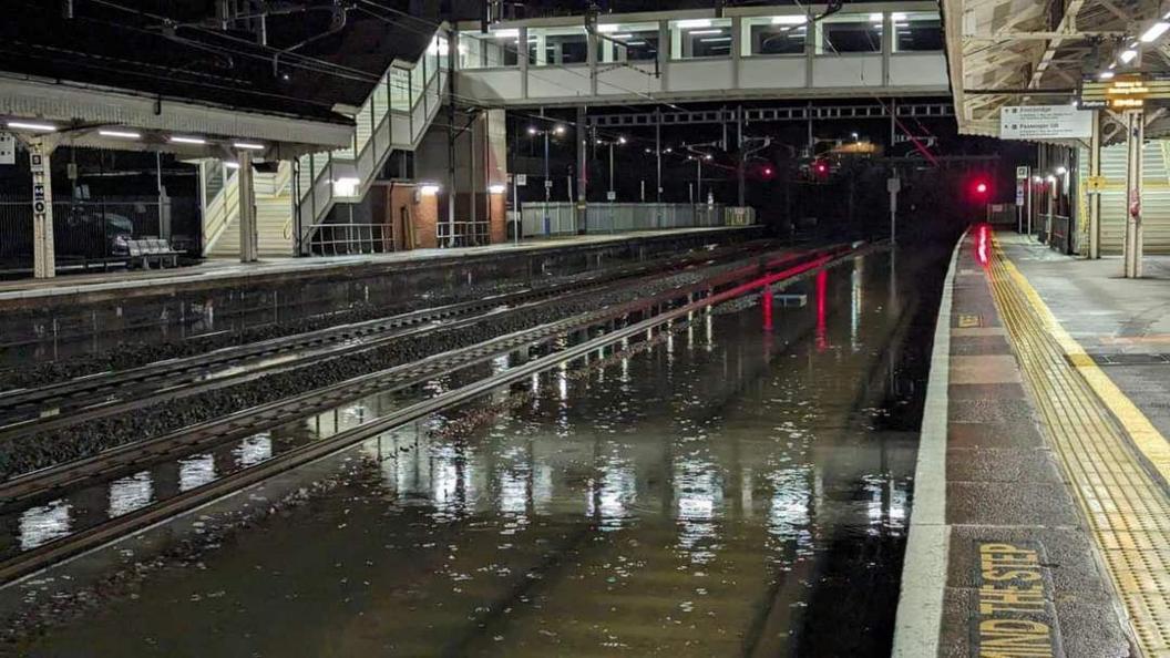 Flooded tracks at a train station