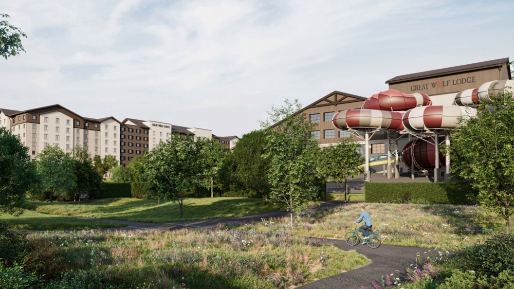 An artist's impression of the proposed Great Wolf Lodge development. To the right is a building with a water slide emerging from it and making various twists and turns. Over to the left is a large hotel.
