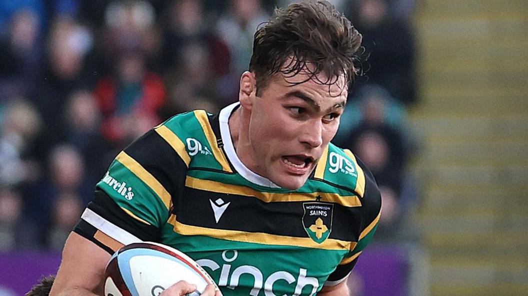 Northampton Saints flanker Josh Kemeny being tackled by a Sale Sharks player