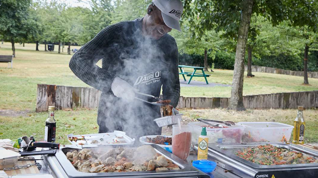 Chef Olajide cooking meat and vegetables on the hotplates  