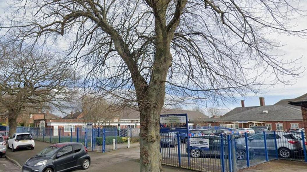 Tang Hall Primary School in York, with cars parked outside the school building. 