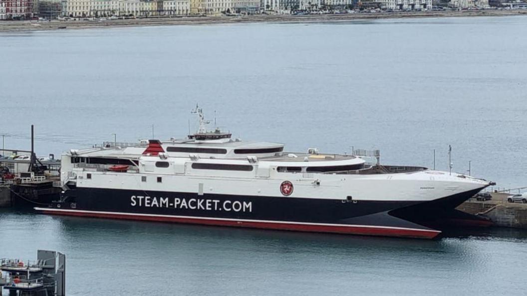 The Manannan, a sleek, white, navy and red catameran, with writing that says SteamPacket.com