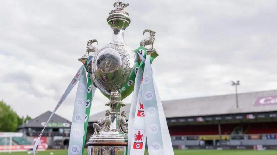 The Welsh Cup trophy on a plinth inside a ground