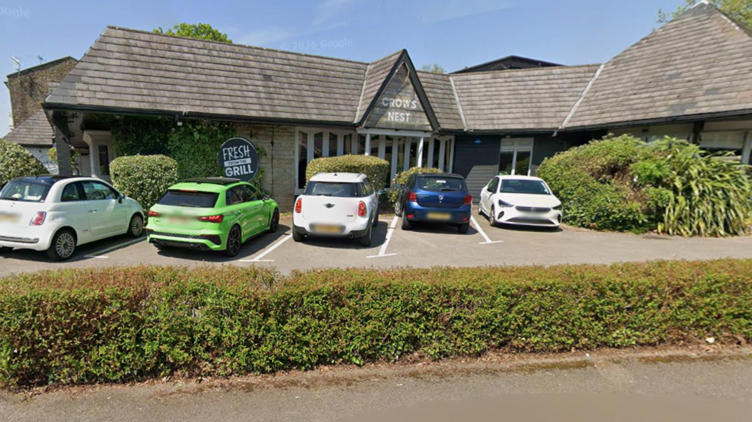 The Crow's Nest Pub exterior with cars parked in the car park in front of the entrance.