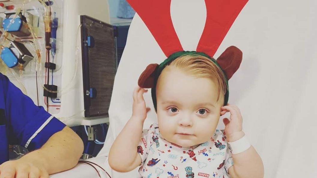 Henry in the hospital with reindeer antlers on 