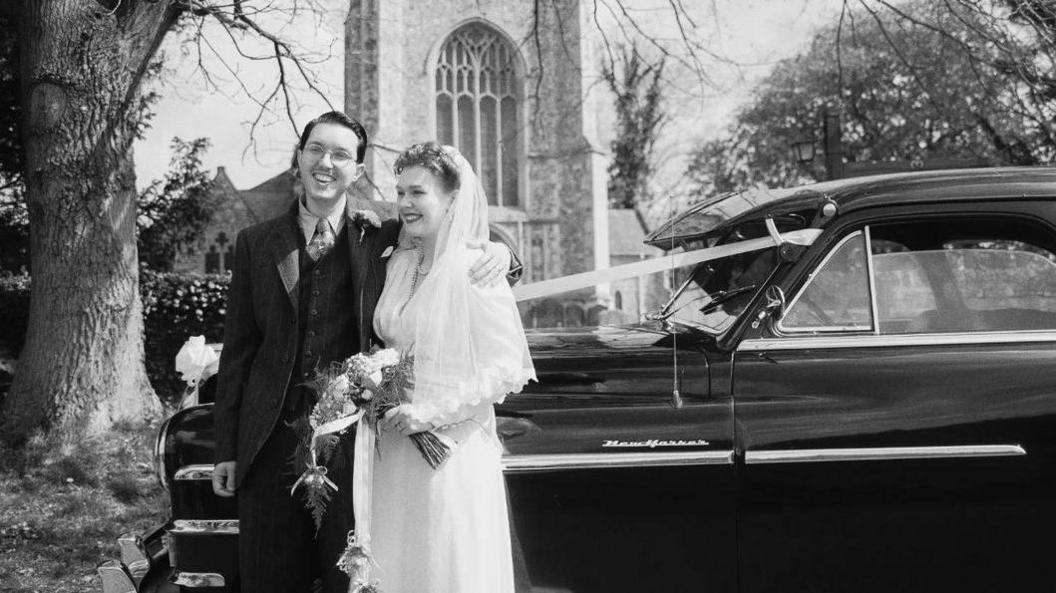 Greg and Liberty on their wedding day outside their vintage wedding day.