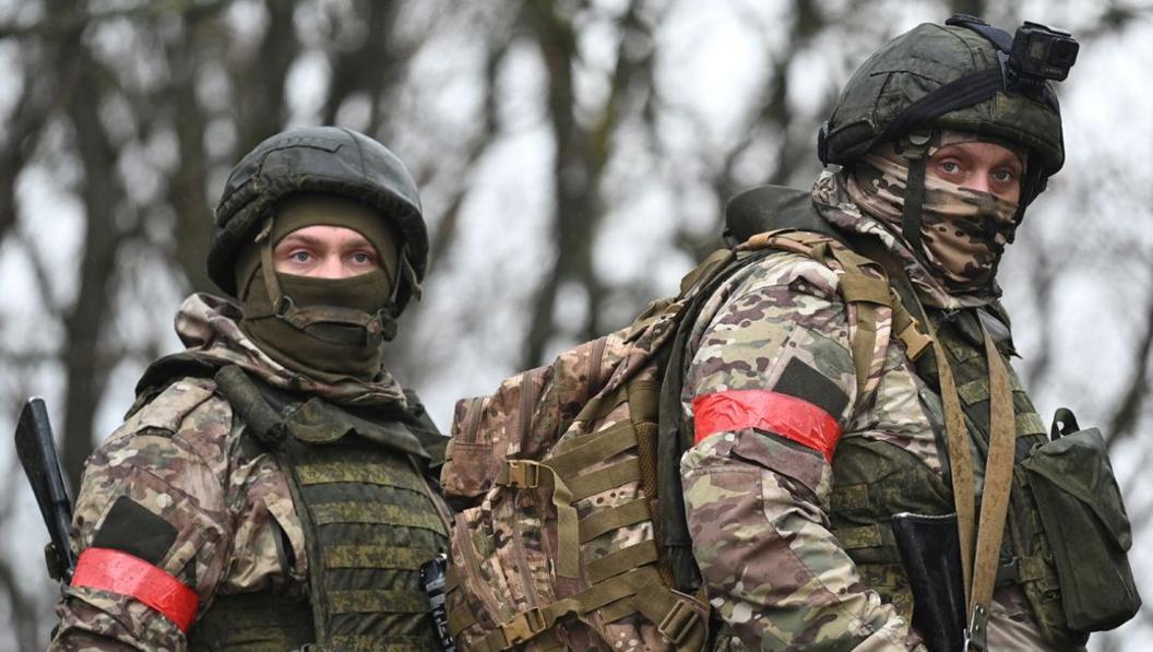 Two Russian service members in camouflage undergo combat training at a firing range, in the course of Russia-Ukraine conflict, in Russia,  December 2024