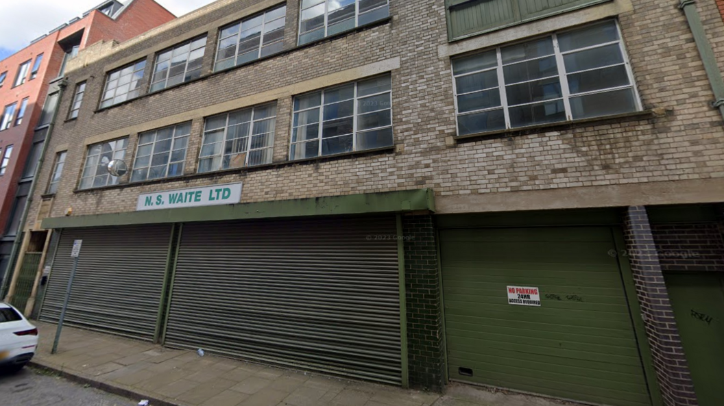 A Google street view image of the NS Waite Ltd building in Leicester, an 1950s factory building with green shutters and an art deco style doorway