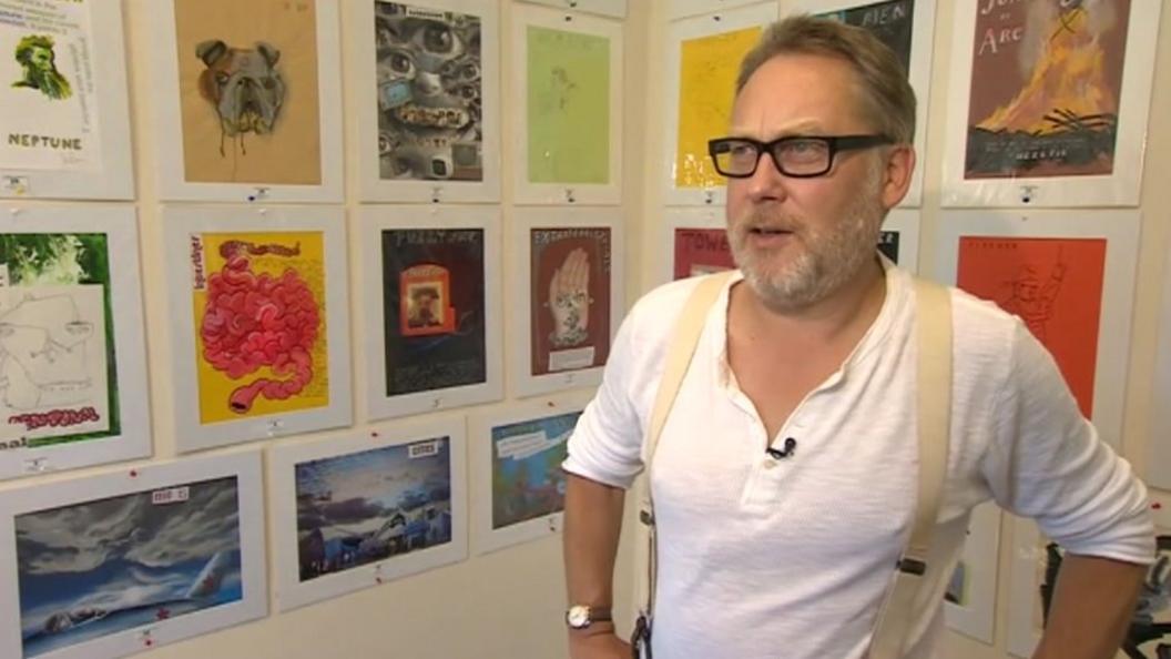 Vic Reeves with his artworks