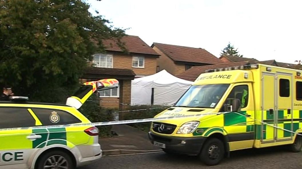 Police vehicles outside the house in Carnegie Gardens