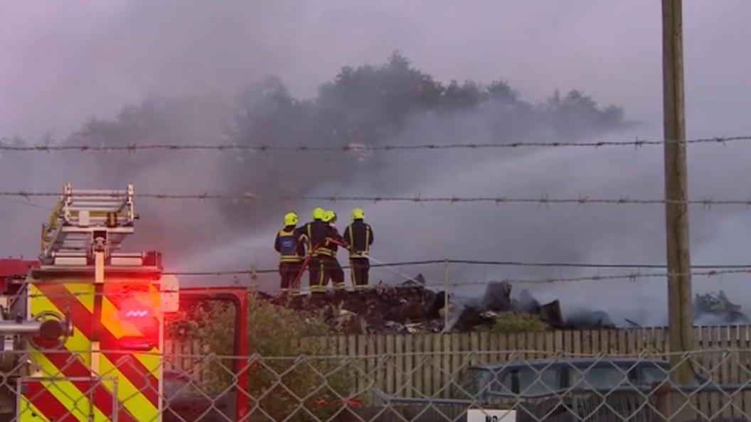 Firefighters work to bring the blaze under control