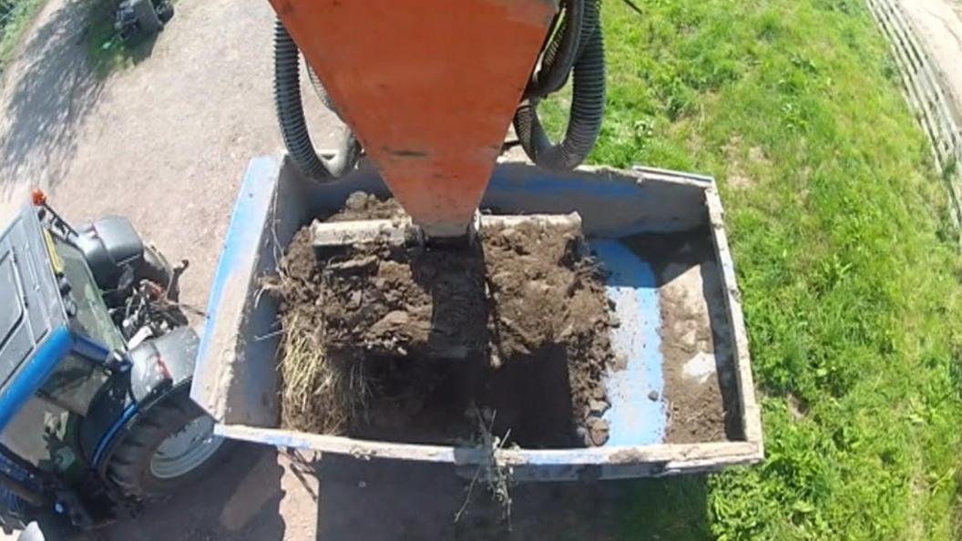 River silt being put in to the back of a lorry