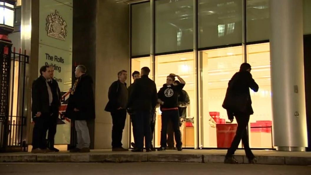 Fans gather outside the Royal Courts of Justice