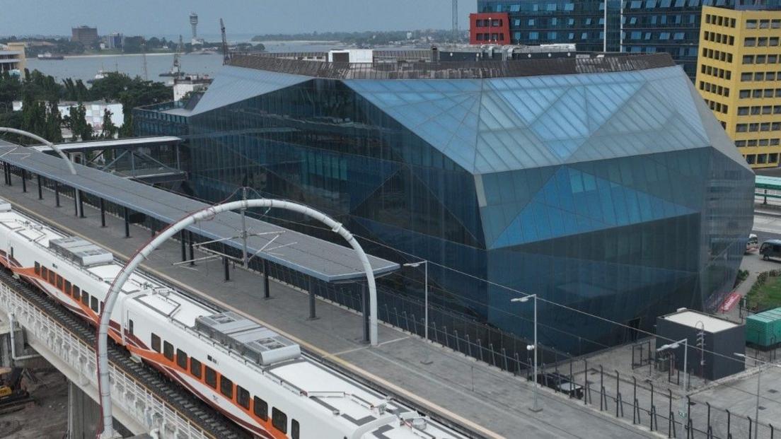 The train station in Dar es Salaam, with a blue, cubic terminal