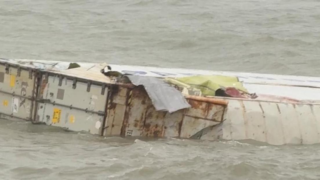 A close up of a floating container which appears to be damaged.