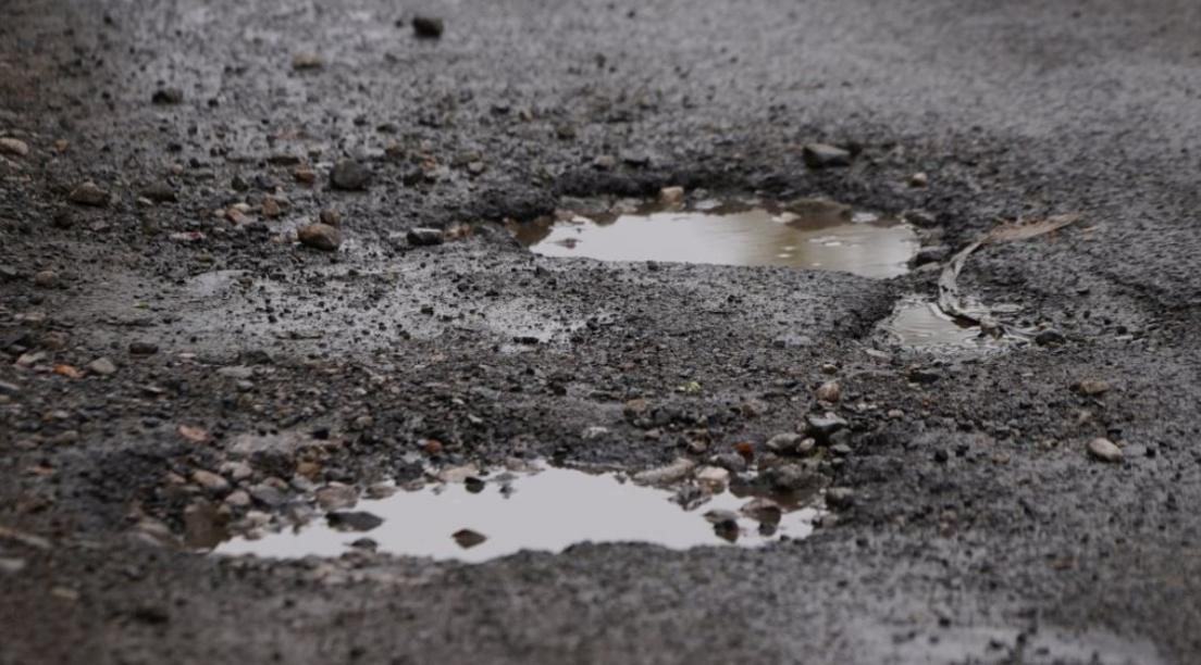 A pothole filled with water on a road