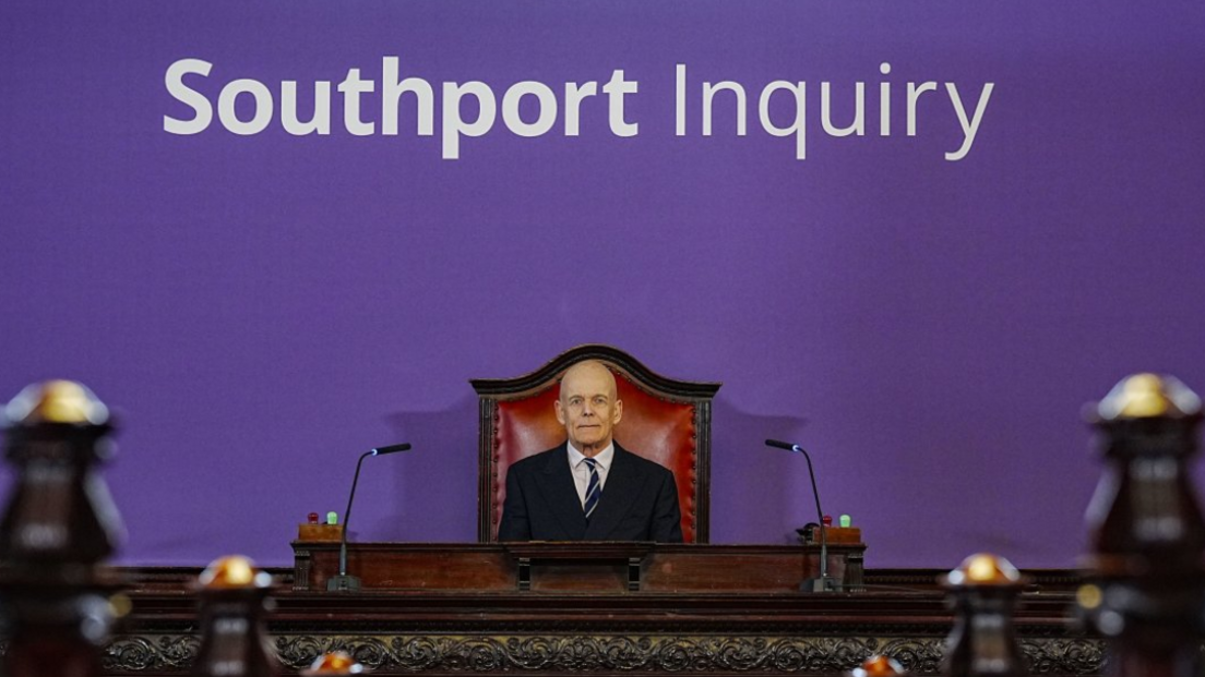 Chair Sir Adrian Fulford sitting inside the hearing room at Liverpool Town Hall, Liverpool, ahead of the start of the inquiry