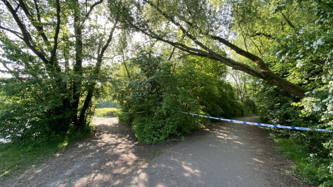 Police tape across a path