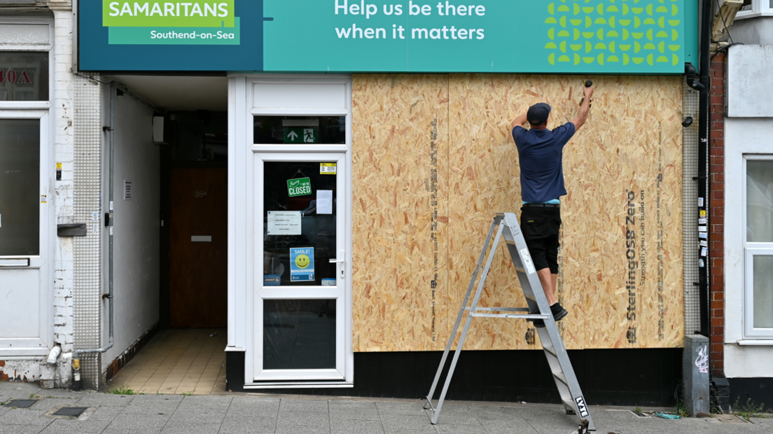 A Samaritans charity shop is boarded up in Westcliff a suburb of Southend, as people protect their property in preparation for more unrest on 7 August