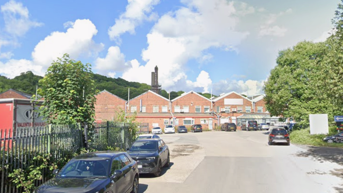 Cars parked in a quiet industrial estate on a sunny day
