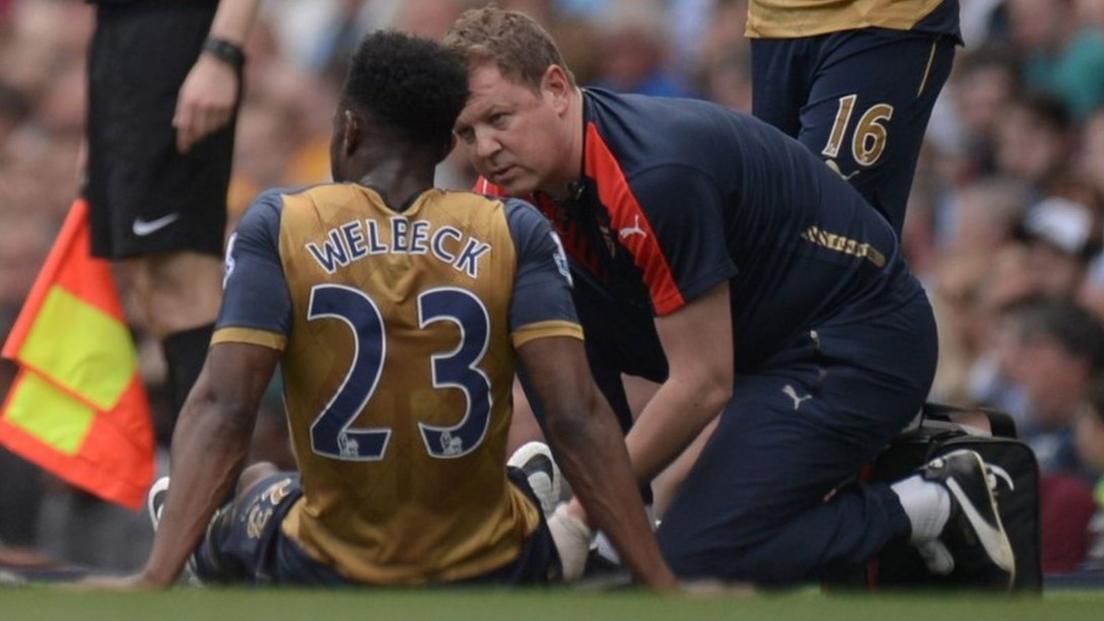 Danny Welbeck receives treatment after injuring his knee