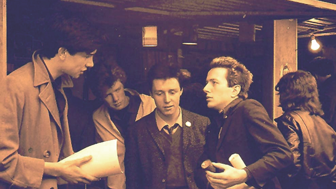 Joe Strummer (fourth from left) outside the Rock on Stall