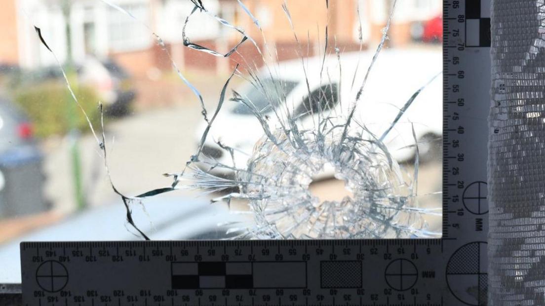 A bullet hole in a window
