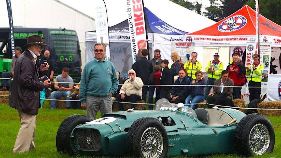 Image of two men near a green vintage car at the Bath Rotary Festival of Motoring