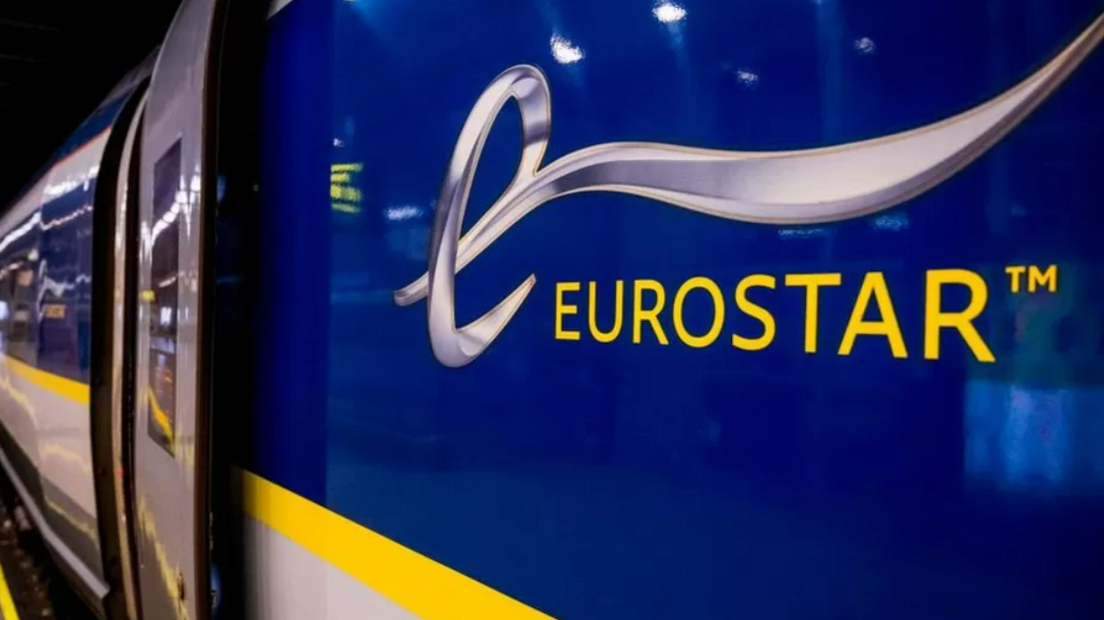 A close up of the side of a Eurostar train, showing the blue, white and yellow logo.