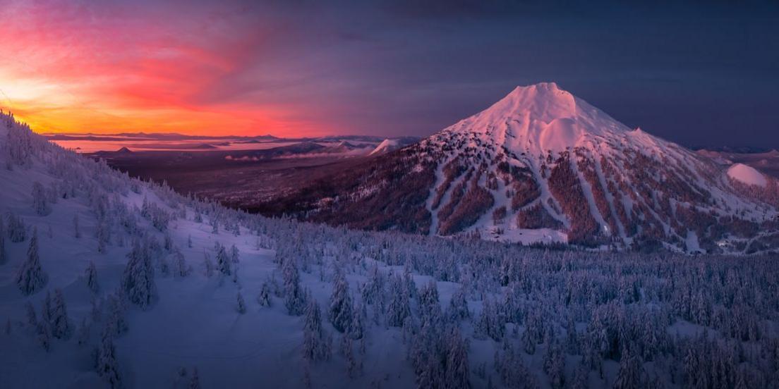 snowy mouintain peak at sunset