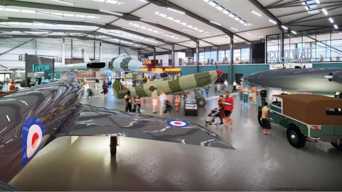 A computer generated image of a hangar. Planes are set up for show and there are educational areas with large lettering signs, for example one says "the cold war" and another says "STEM". Lots of people are walking around and looking at the things on show.