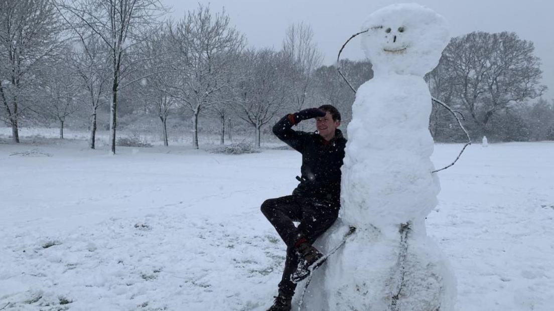 A photo of a snowman in a snow-covered park