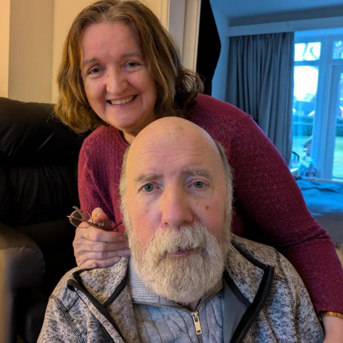 Terry Walters sitting down and his wife Janet perched behind him