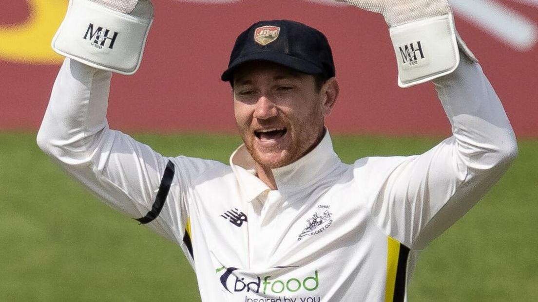 Gloucestershire wicketkeeper James Bracey celebrates a wicket